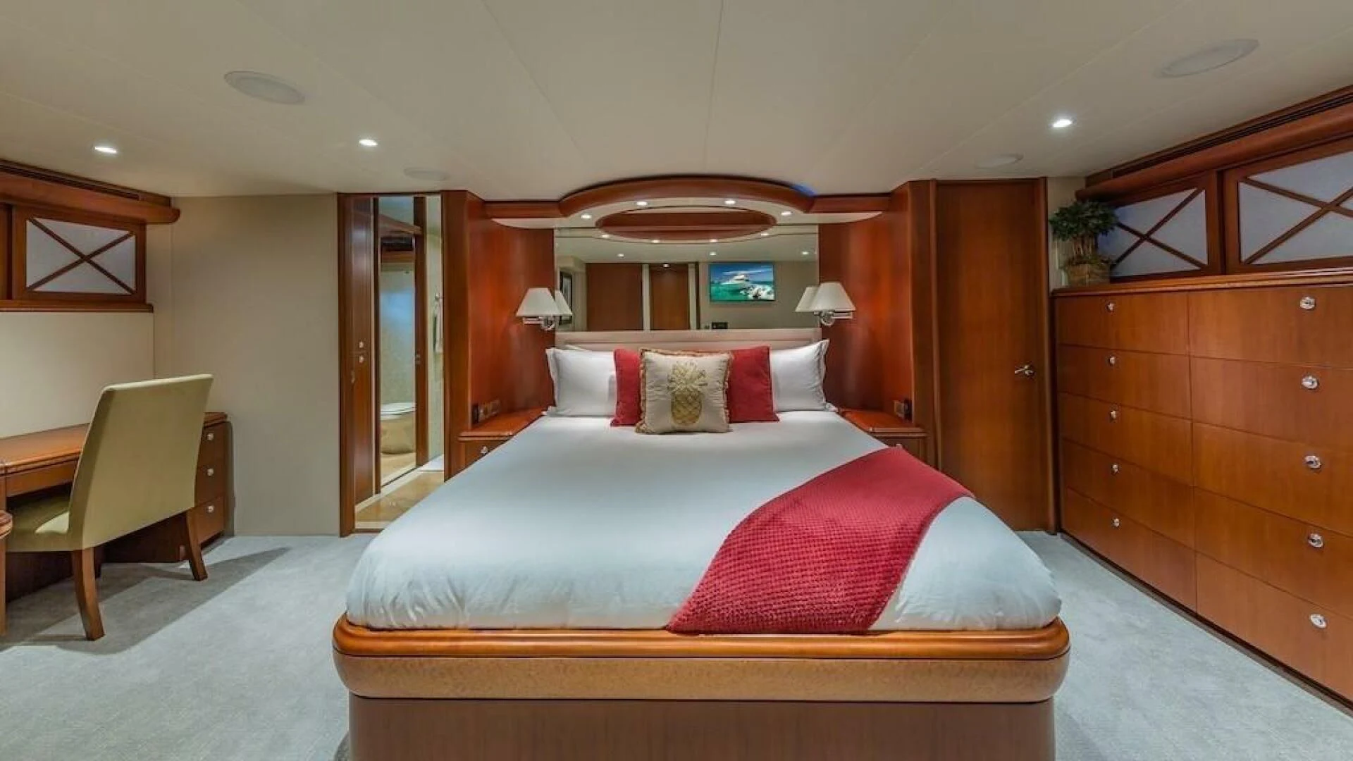 a bed with red and white pillows aboard LADY LORRAINE Yacht for Sale
