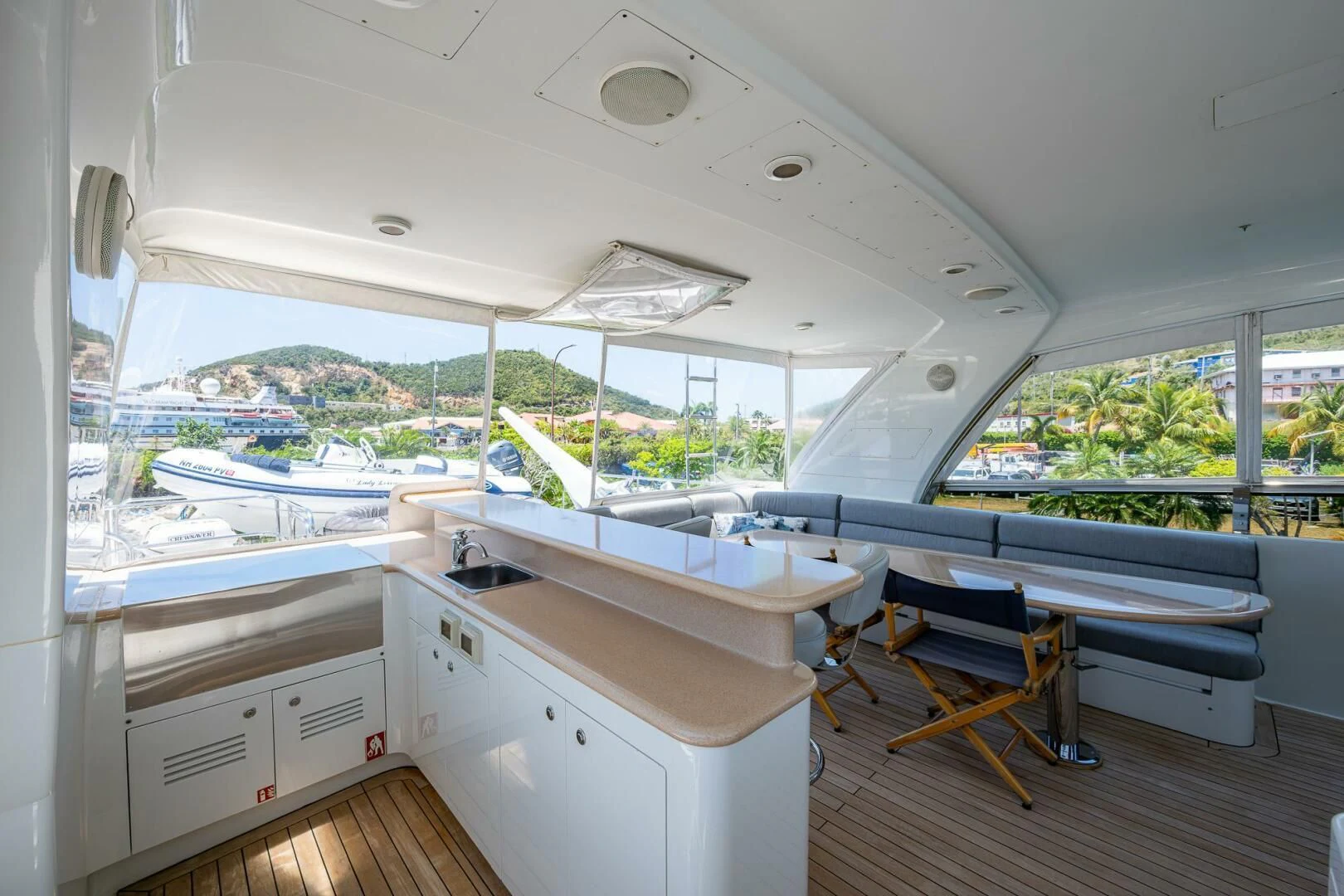 a room with a large window and a table with chairs aboard LADY LORRAINE Yacht for Sale
