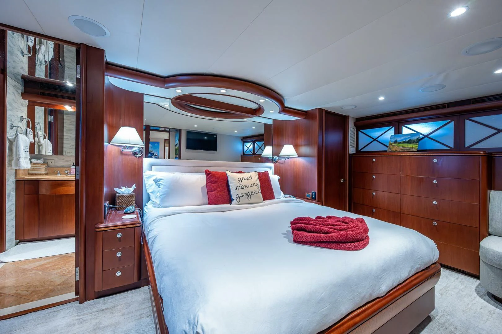 a bedroom with a bed and a mirror aboard LADY LORRAINE Yacht for Sale