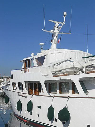 a white boat with a wind turbine on top aboard ALMORIA Yacht for Sale