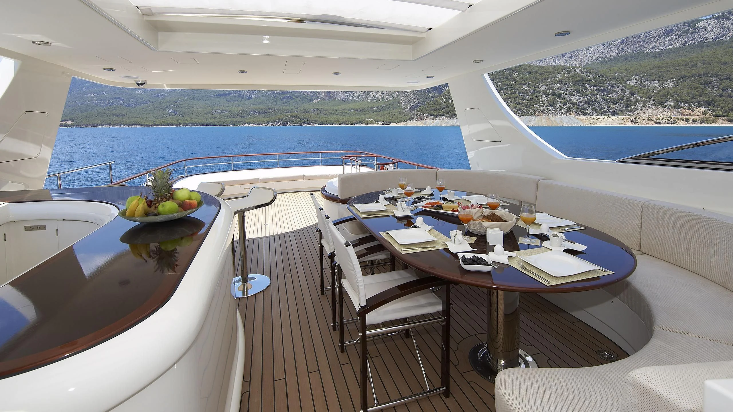 a table with chairs and a view of the ocean aboard CYRUS ONE Yacht for Sale