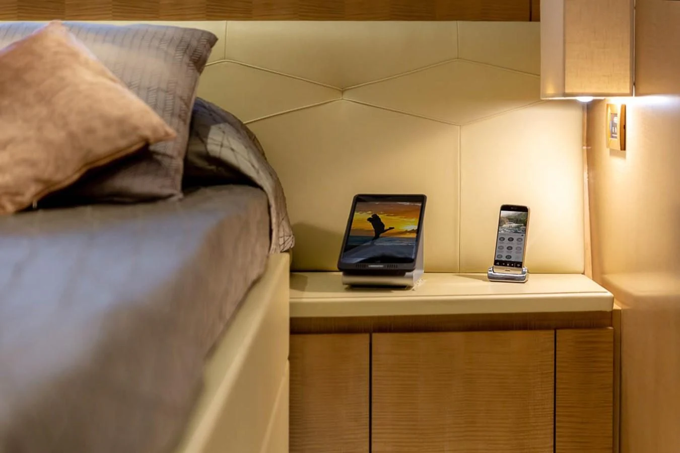 a bed with a phone on it aboard X-TREM II Yacht for Sale