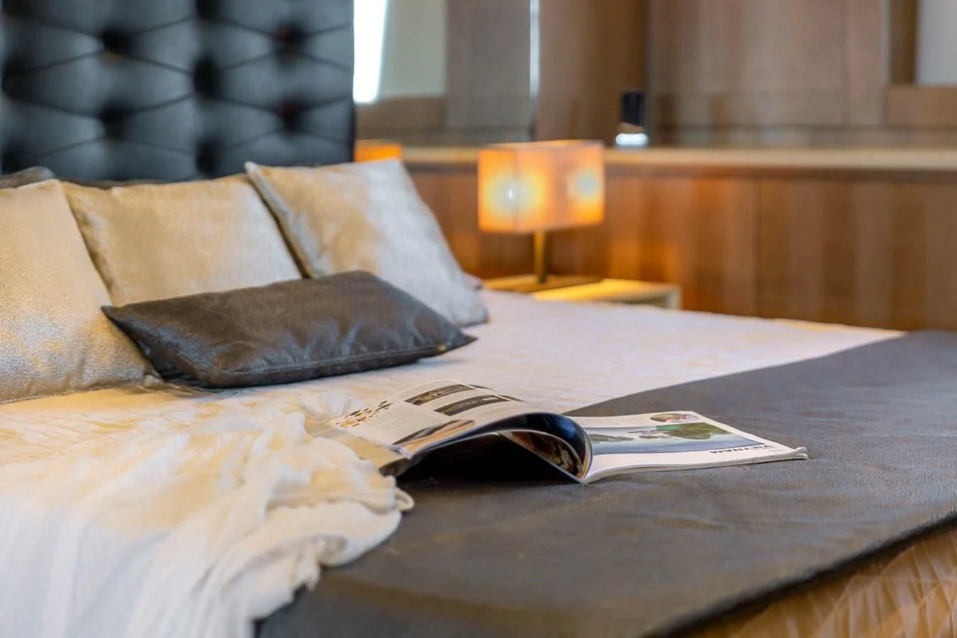 a book on a bed aboard X-TREM II Yacht for Sale