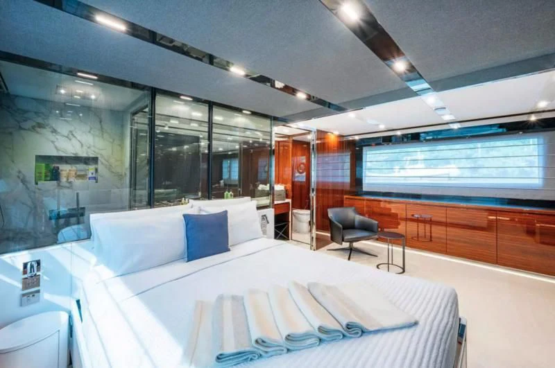 a room with a bed and a desk aboard RIVA FOLGORE 88/14 Yacht for Sale
