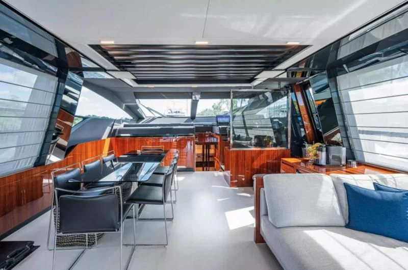inside of a building with a large glass window and a table and chairs aboard RIVA FOLGORE 88/14 Yacht for Sale