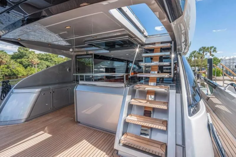 a large open space with a deck and a large building aboard RIVA FOLGORE 88/14 Yacht for Sale