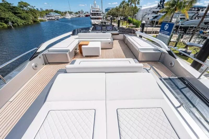 a deck with a deck and a body of water with boats in the background aboard RIVA FOLGORE 88/14 Yacht for Sale