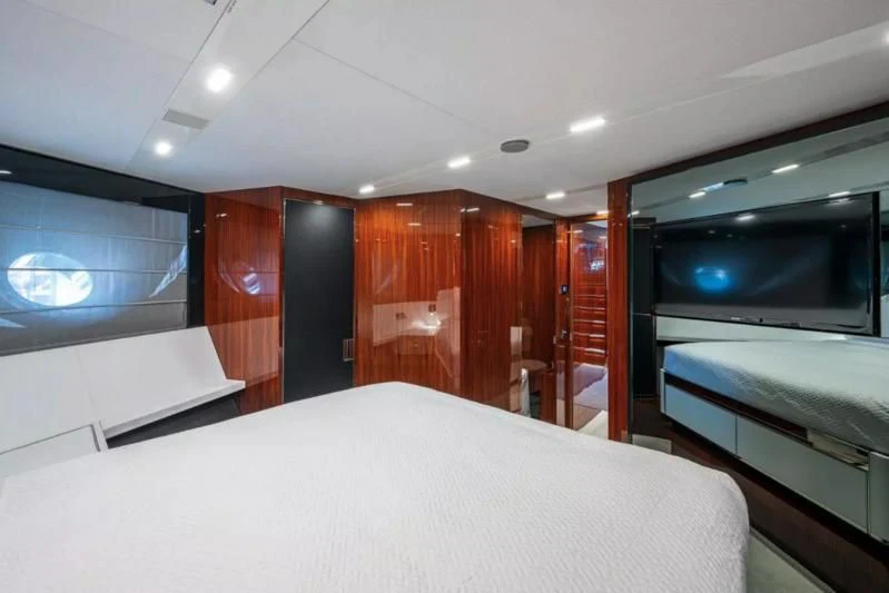 a room with a bed and a television aboard RIVA FOLGORE 88/14 Yacht for Sale