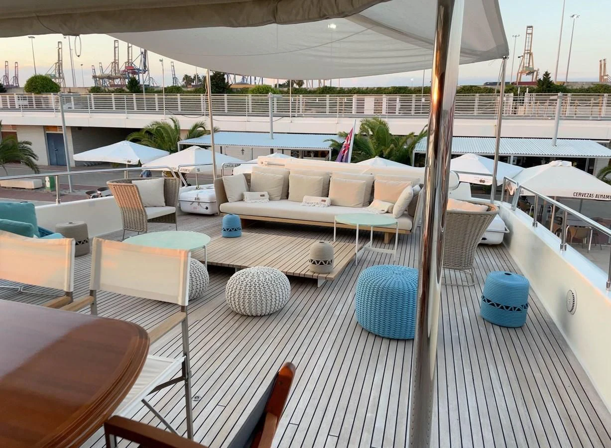 a deck with a pool and lounge chairs aboard BIM Yacht for Sale