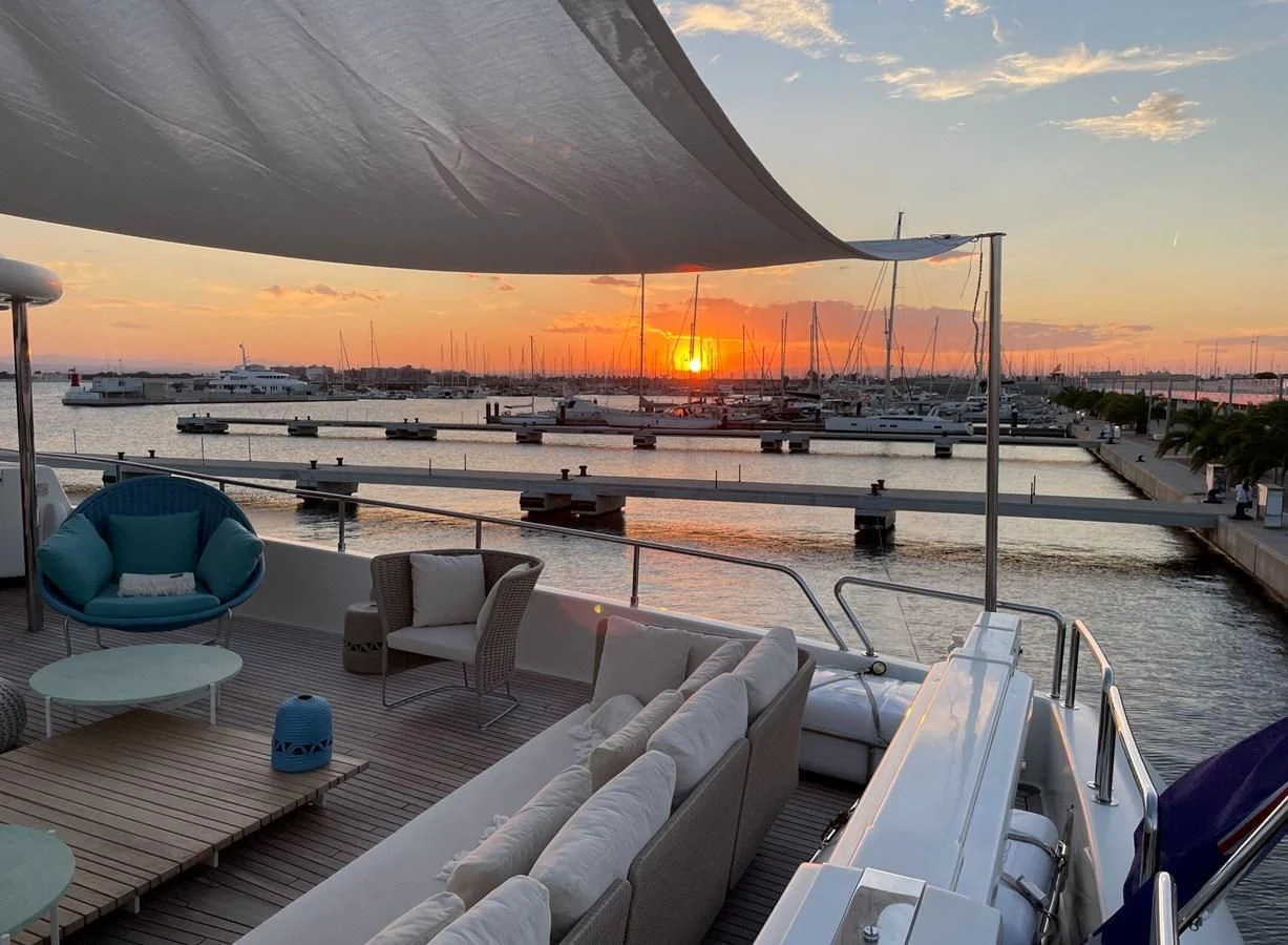 a patio with a view of a sunset and a body of water aboard BIM Yacht for Sale