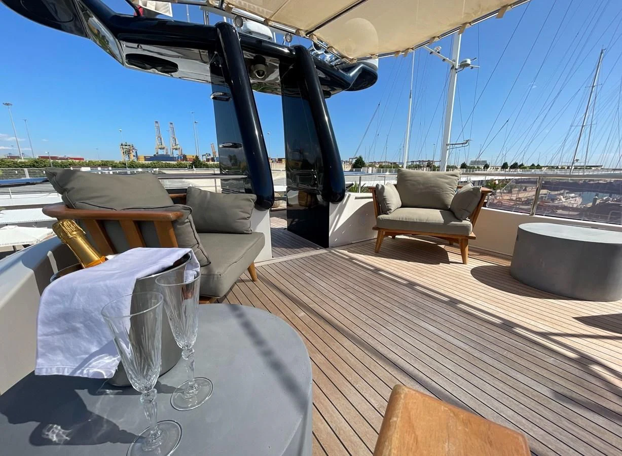 a glass table on a deck aboard BIM Yacht for Sale