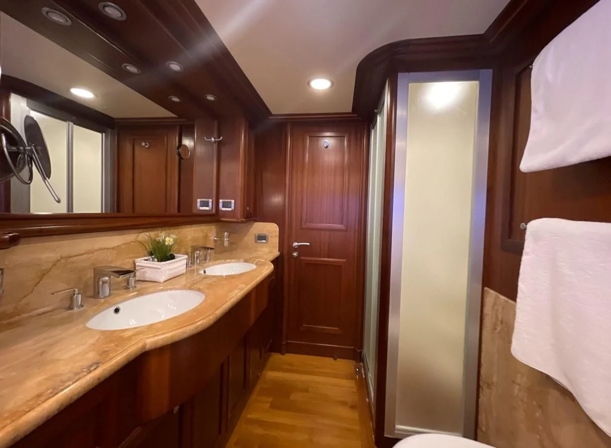 a bathroom with a sink and a mirror aboard BIM Yacht for Sale
