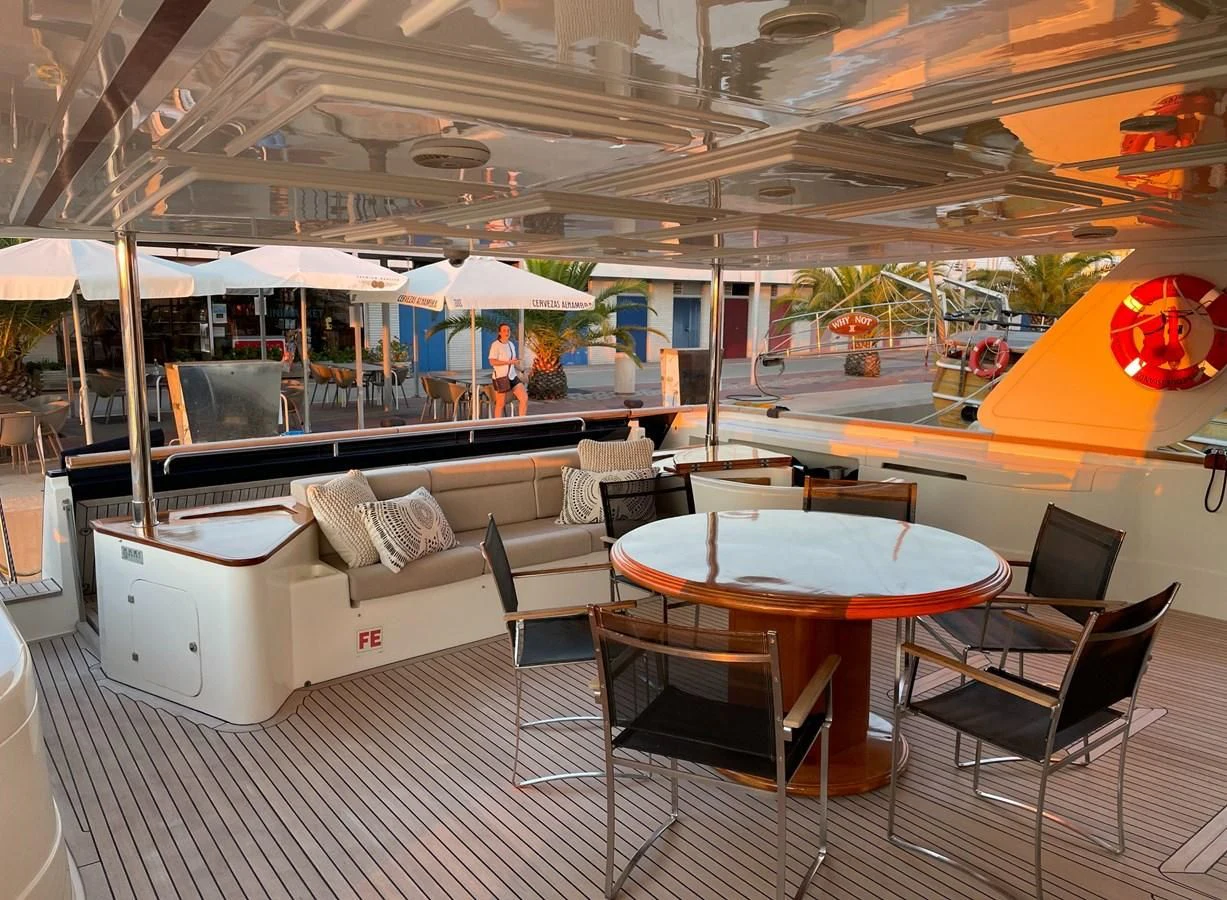 a room with a table and chairs aboard BIM Yacht for Sale