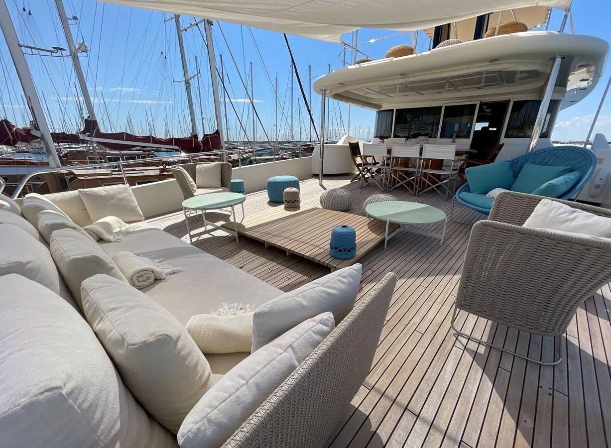 a large lounge area with a large umbrella aboard BIM Yacht for Sale