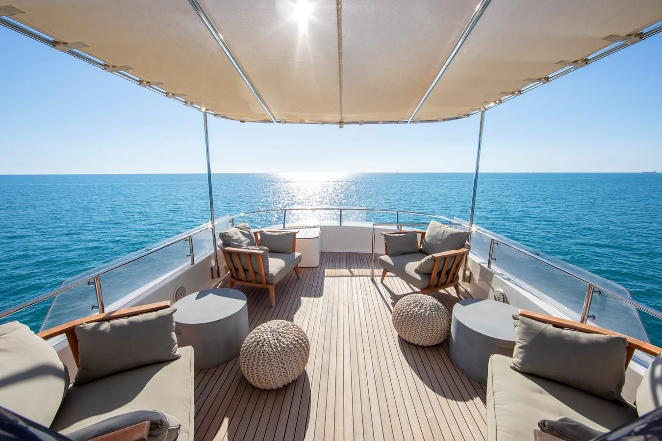 a deck with chairs and a large body of water aboard BIM Yacht for Sale