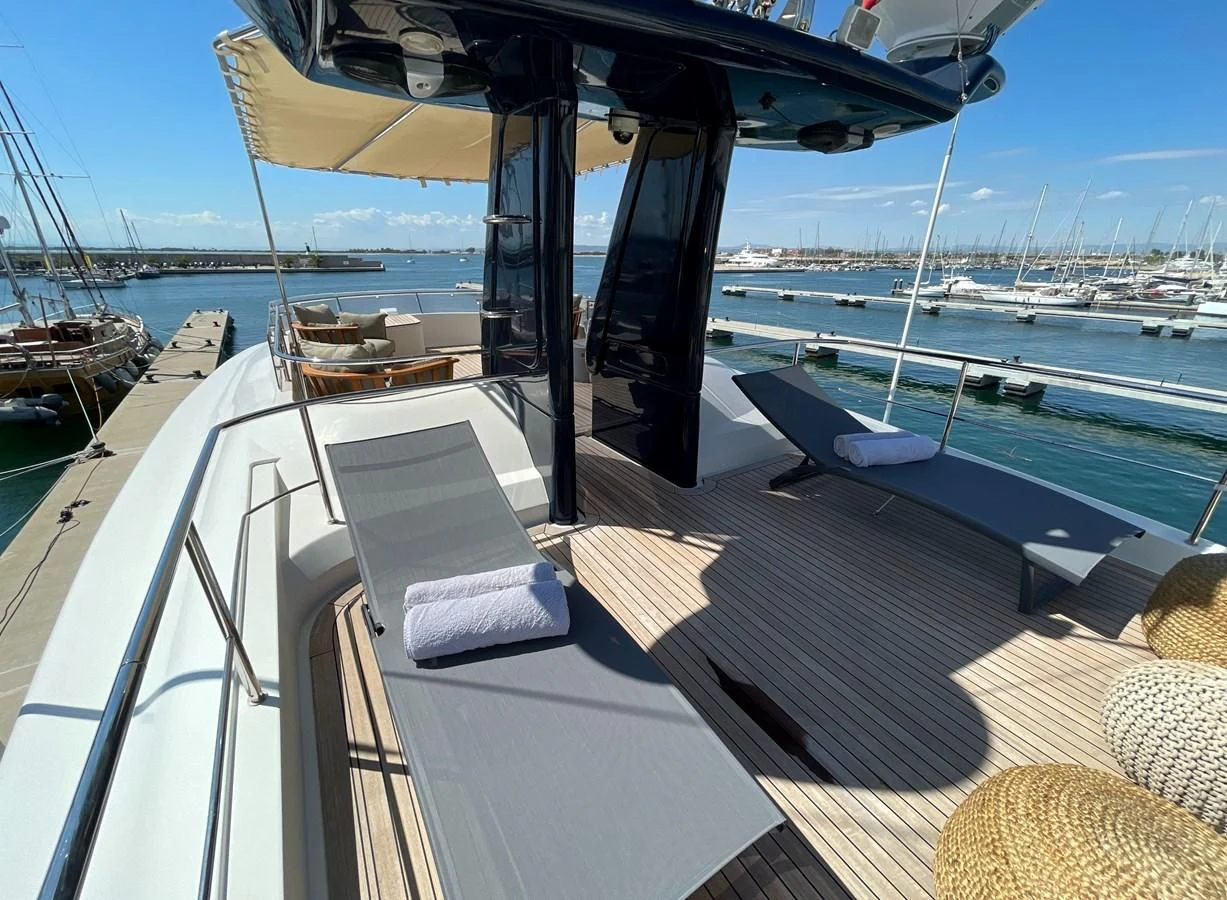 a deck with a view of the water and boats aboard BIM Yacht for Sale
