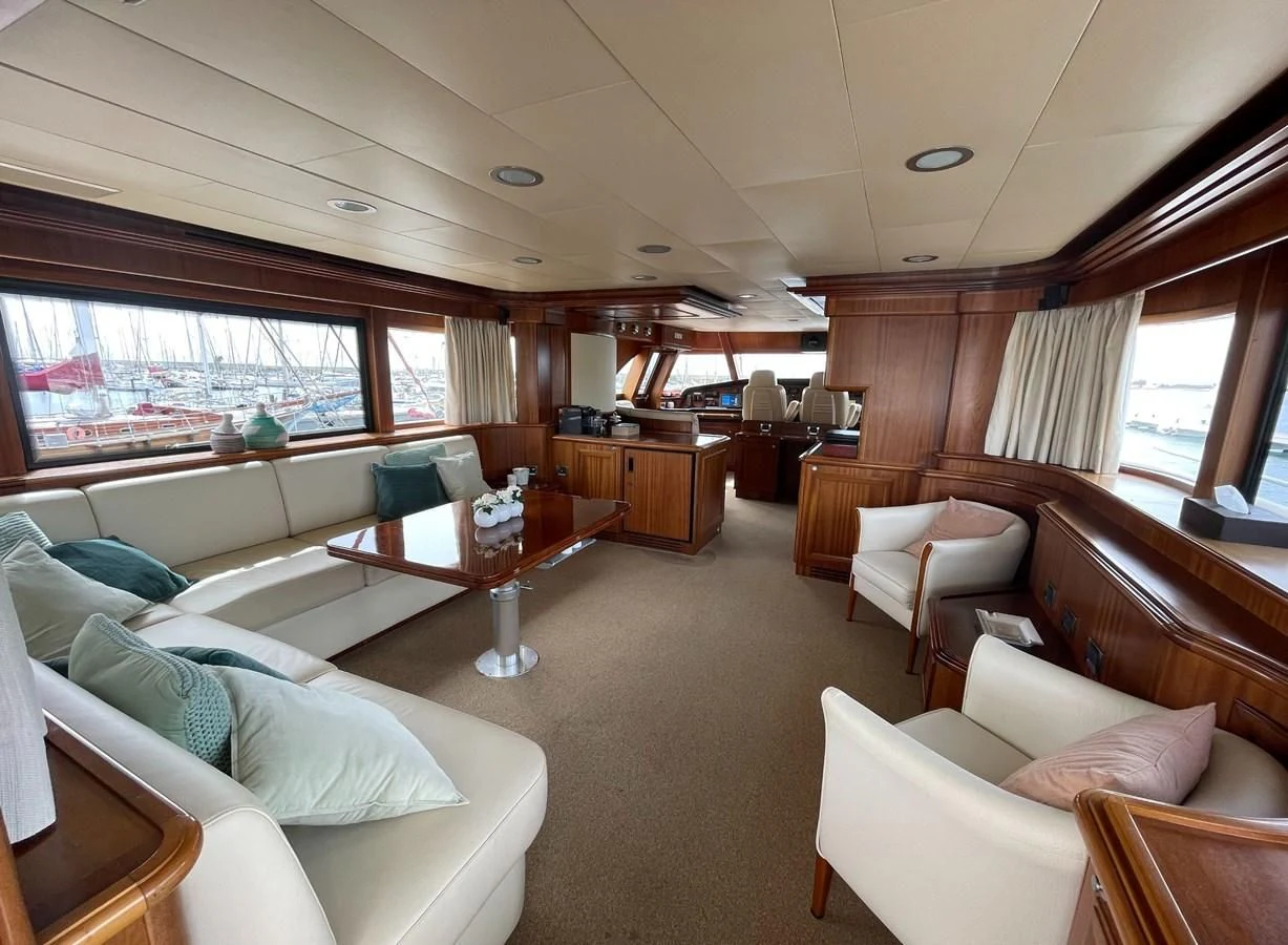 a living room with a large window aboard BIM Yacht for Sale