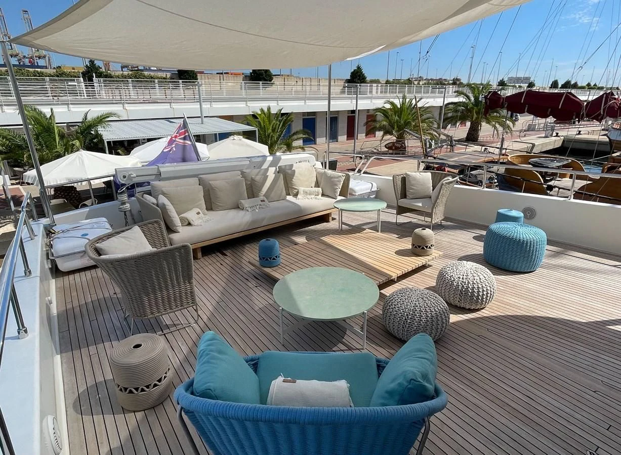a patio with a pool and lounge chairs aboard BIM Yacht for Sale