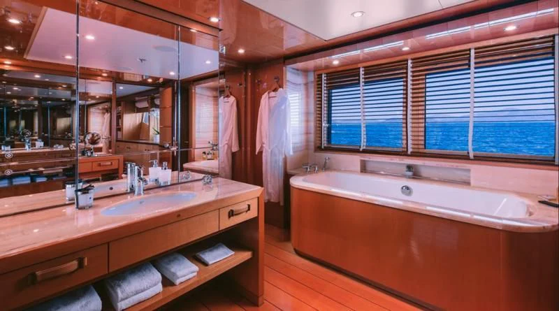 a bathroom with a large mirror aboard ARIELA Yacht for Sale
