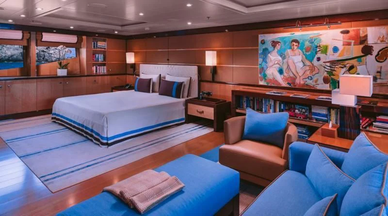 a room with a bed and a couch aboard ARIELA Yacht for Sale