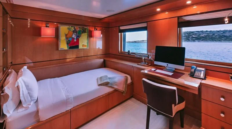 a room with a bed and a desk aboard ARIELA Yacht for Sale