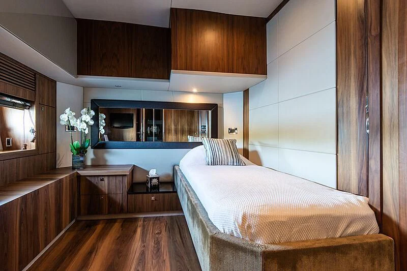 a bedroom with wood cabinets aboard BASAD Yacht for Sale