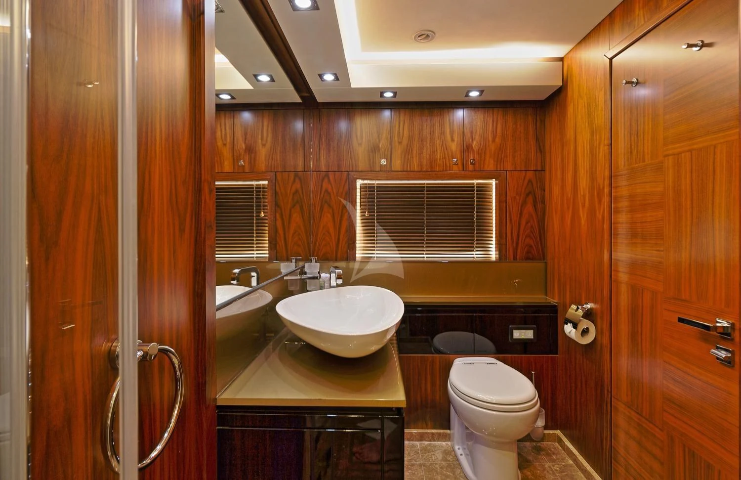 a bathroom with wooden cabinets aboard BASAD Yacht for Sale
