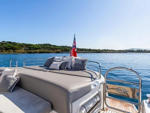 a boat with a red sail on the water aboard BASAD Yacht for Sale