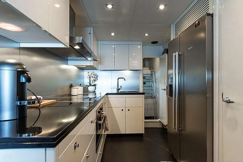 a kitchen with a stainless steel refrigerator aboard BASAD Yacht for Sale