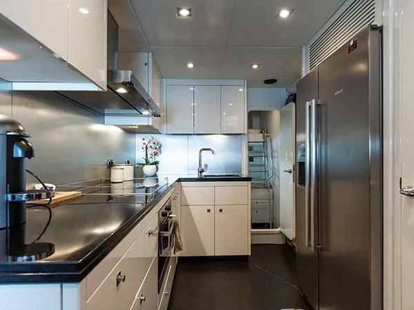 a kitchen with white cabinets aboard BASAD Yacht for Sale