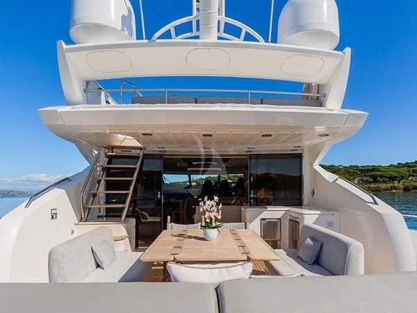 a large white boat with a table and chairs on a deck aboard BASAD Yacht for Sale