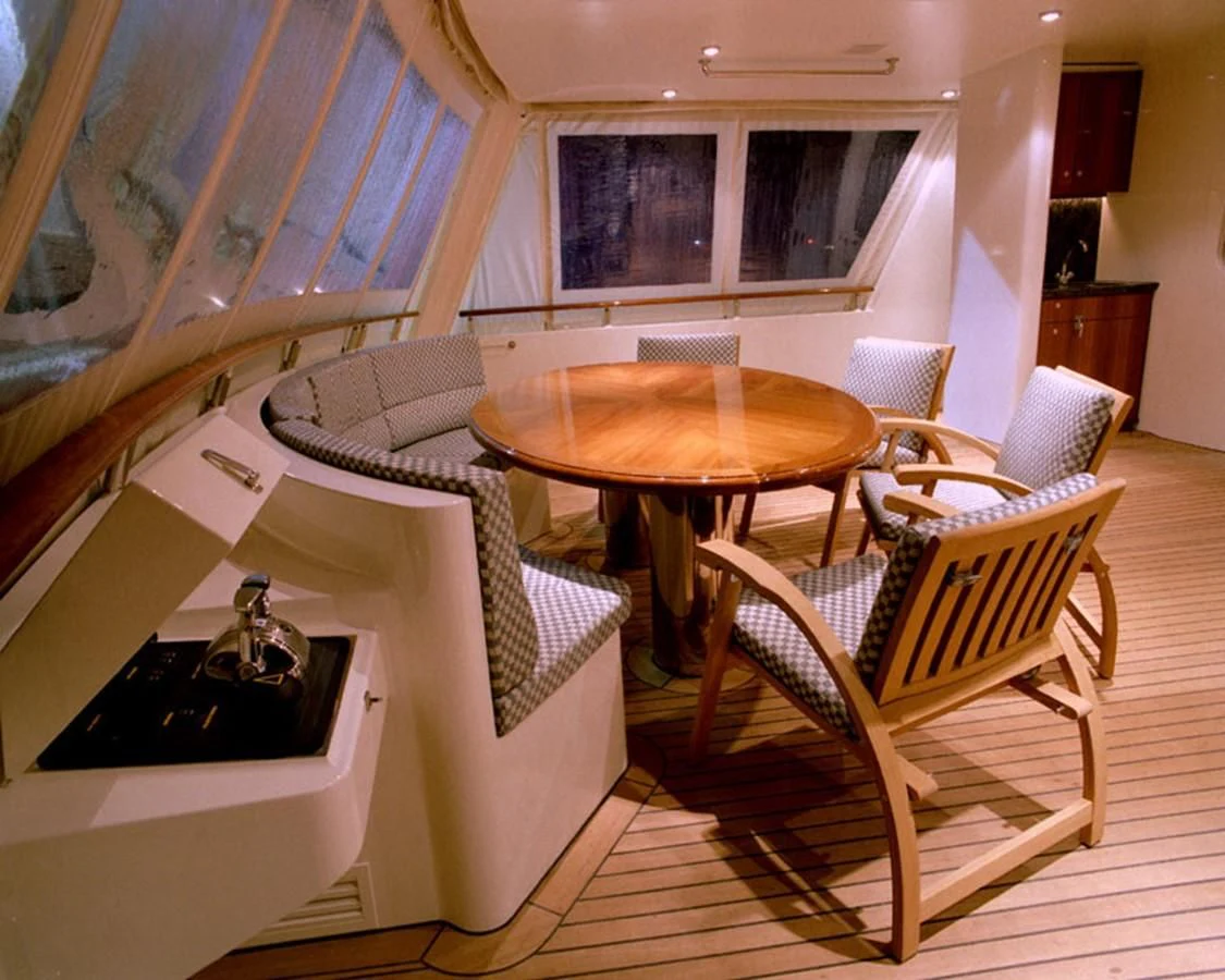 a room with a table and chairs aboard MAVERICK Yacht for Sale