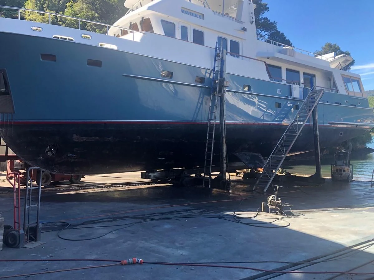 a large white boat on a dock aboard MAVERICK Yacht for Sale
