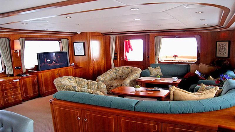 a living room with a couch and a television aboard MAVERICK Yacht for Sale