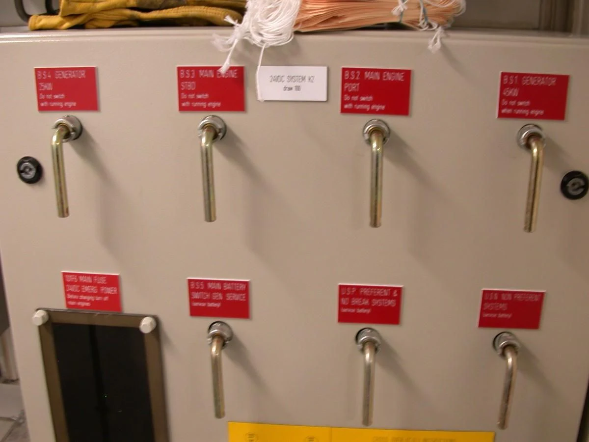 a wall with a few faucets and signs on it aboard MAVERICK Yacht for Sale