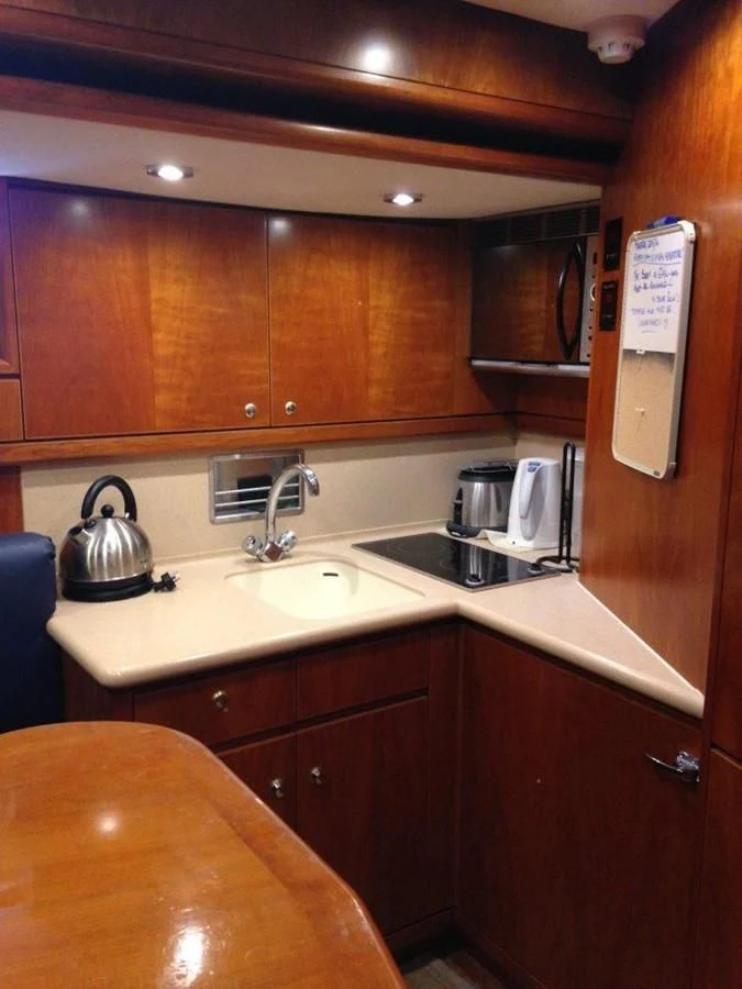 a kitchen with wooden cabinets aboard MAVERICK Yacht for Sale