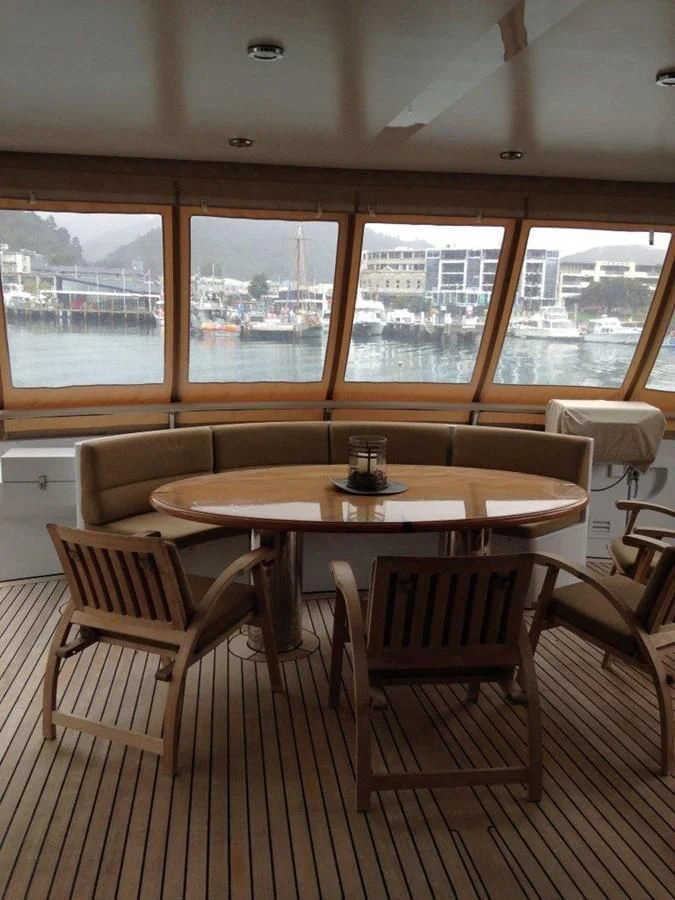 a table and chairs in a room aboard MAVERICK Yacht for Sale