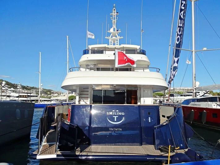 a boat docked at a pier aboard SMILING T Yacht for Sale