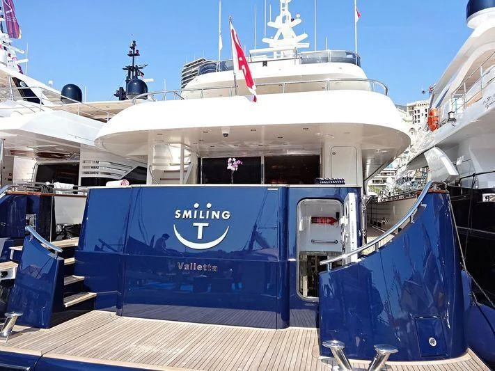 a large boat with a blue canopy aboard SMILING T Yacht for Sale