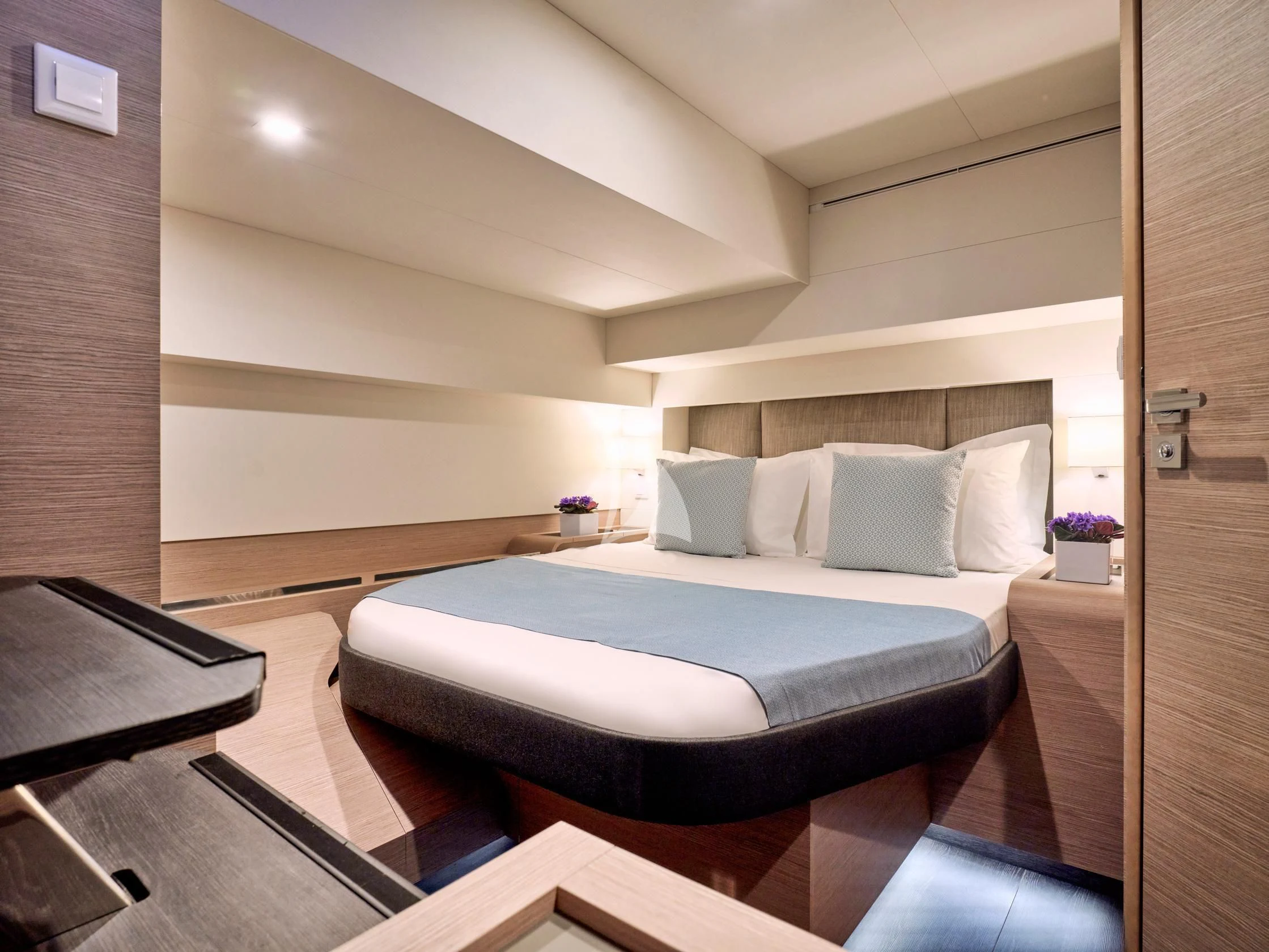 a room with a bed and a desk aboard APHAEA Yacht for Charter