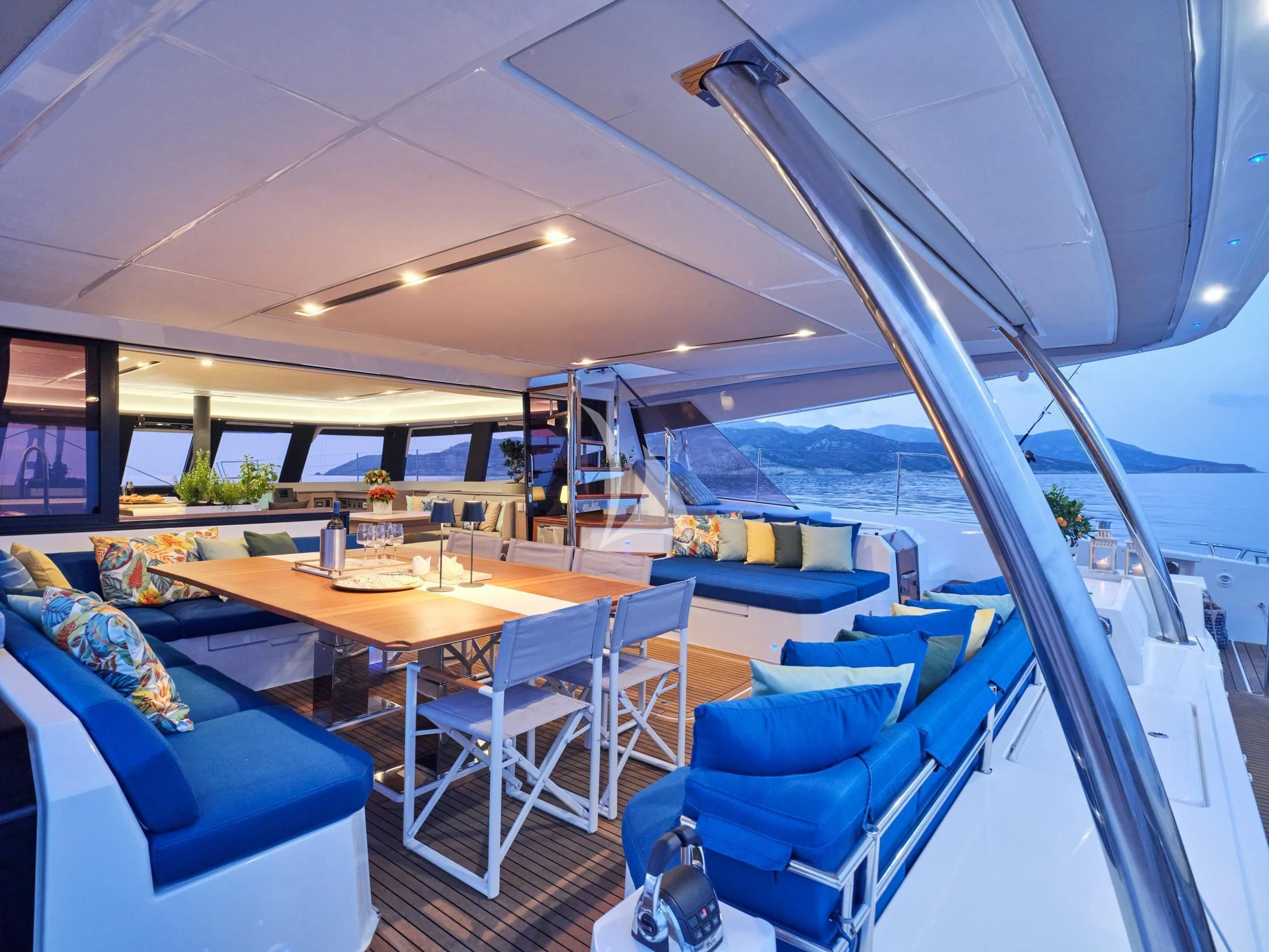 a room with a table chairs and a large window aboard APHAEA Yacht for Charter