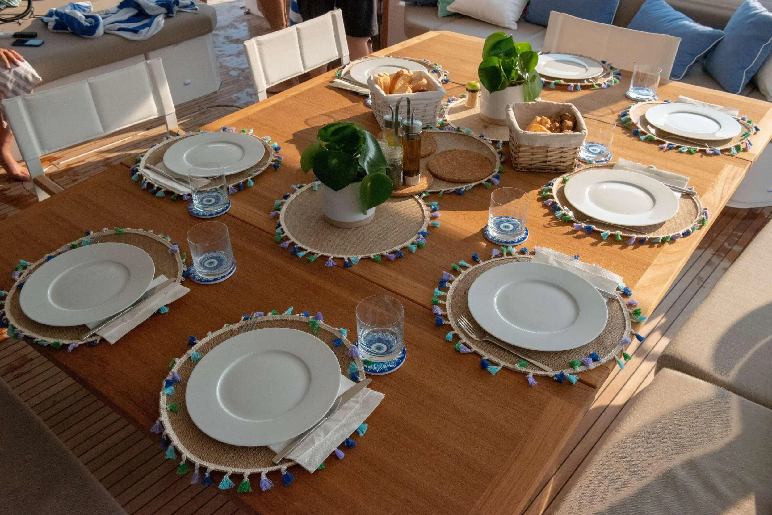 a table with plates and glasses aboard APHAEA Yacht for Charter