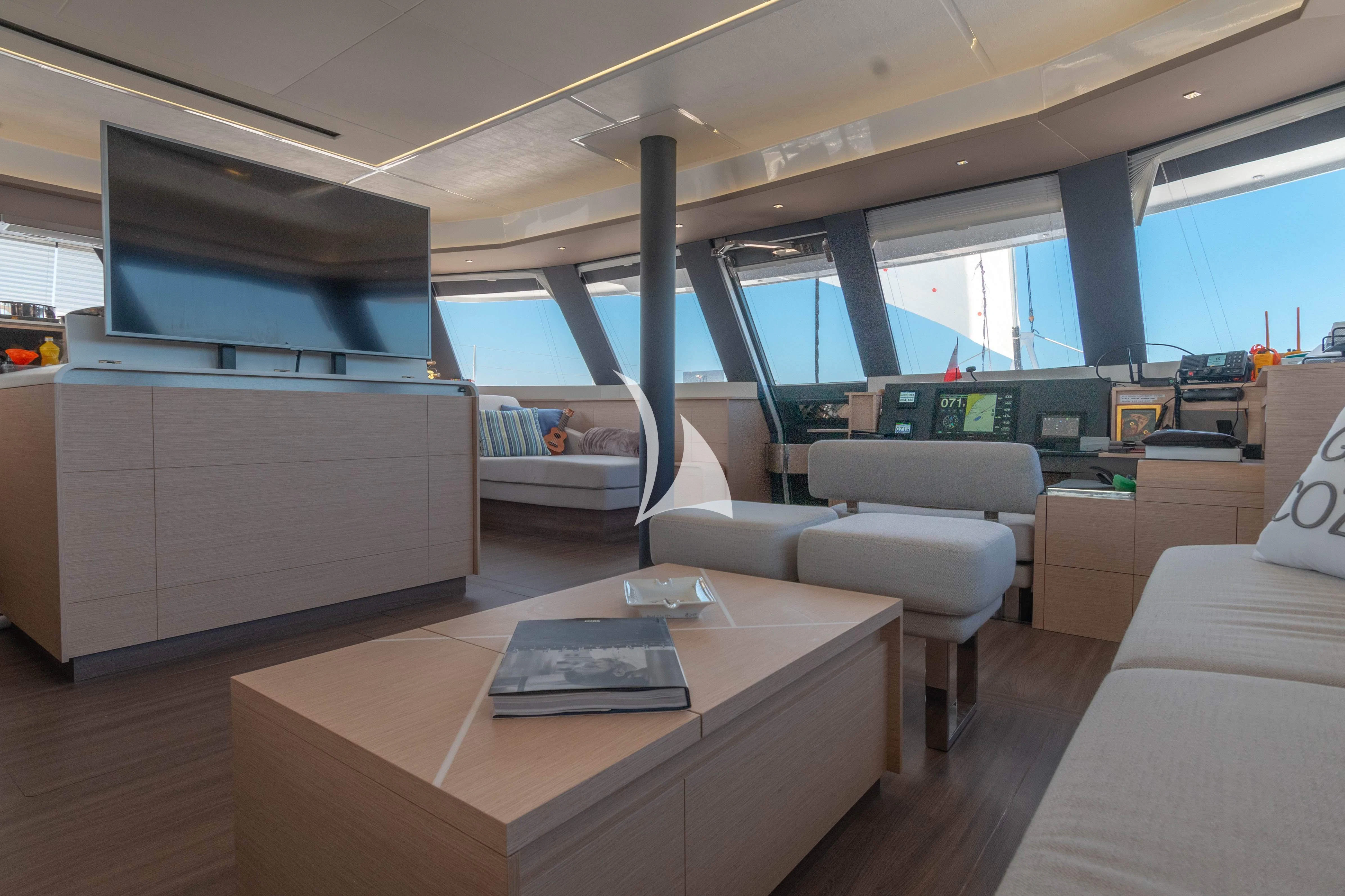 a room with a table and couches aboard APHAEA Yacht for Charter