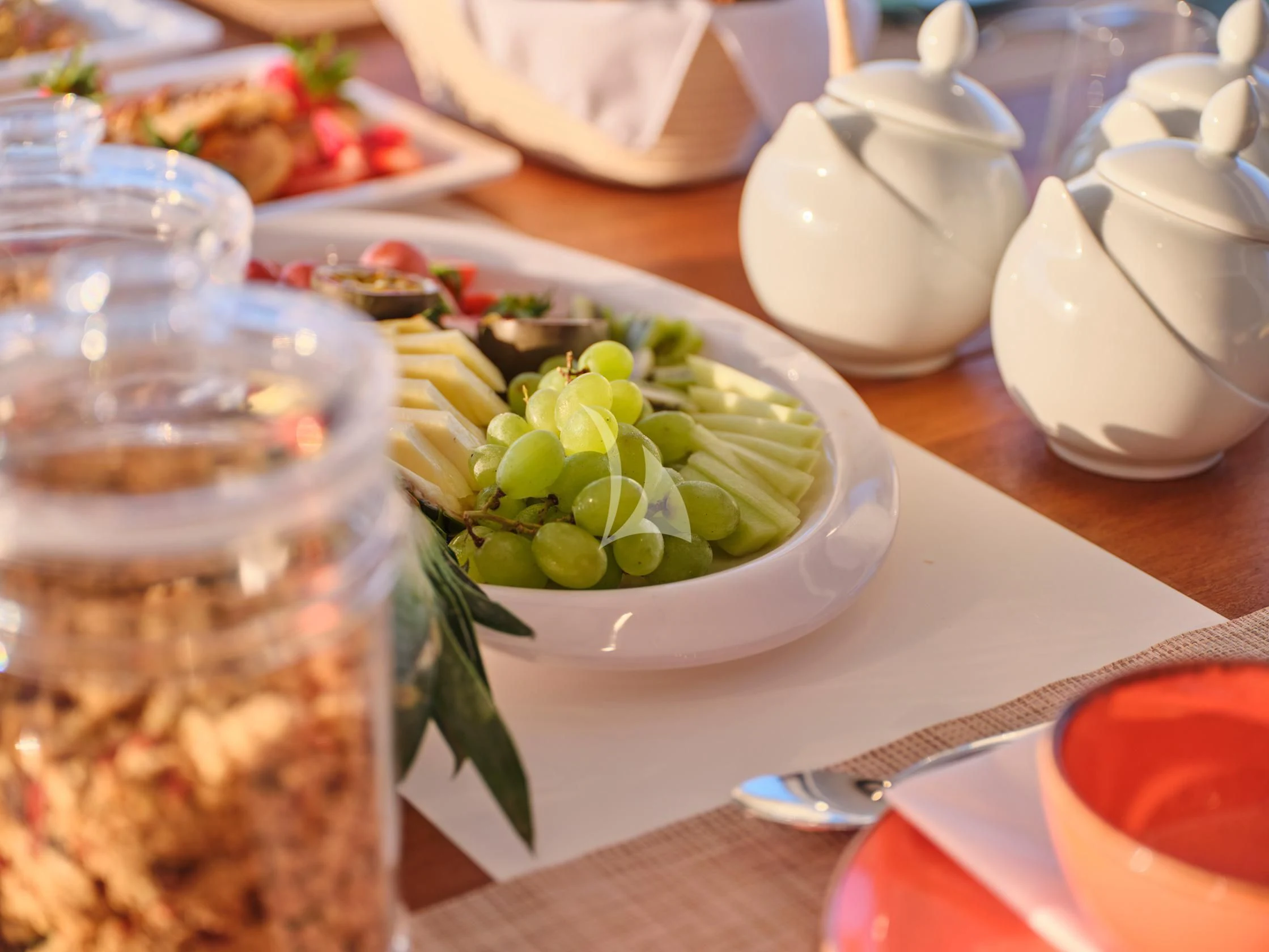 a table with food and glasses aboard APHAEA Yacht for Charter
