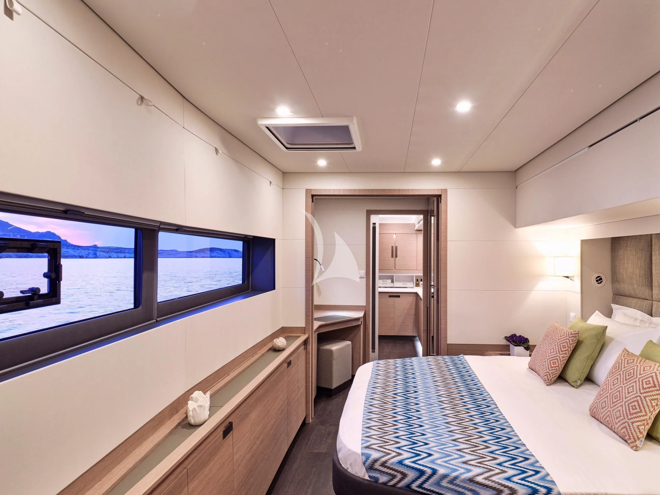 a bedroom with a bed and a tv aboard APHAEA Yacht for Charter