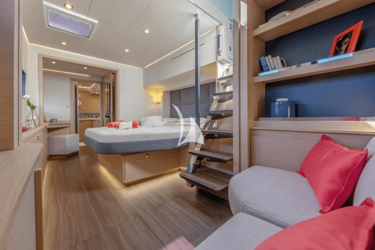 a bedroom with a bed and a bookcase aboard APHAEA Yacht for Charter