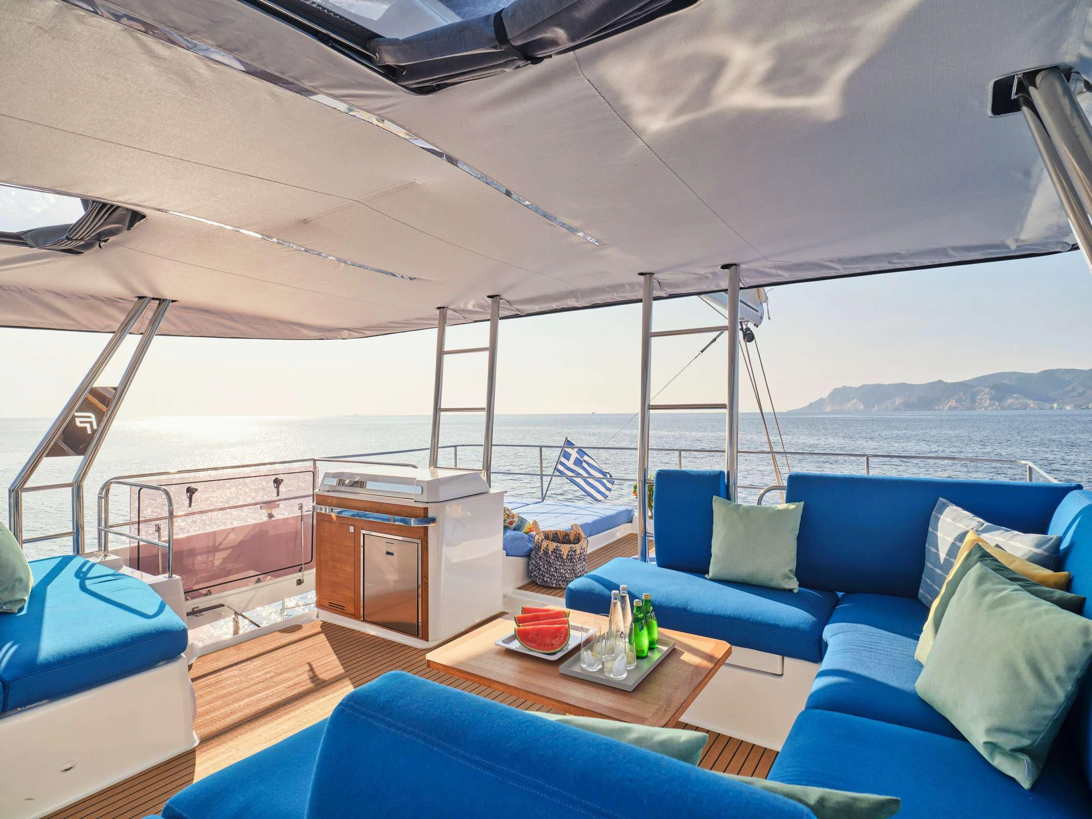 a boat with a table and a couch aboard APHAEA Yacht for Charter