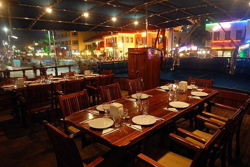 a restaurant with tables and chairs aboard BAHRIYELI C Yacht for Sale