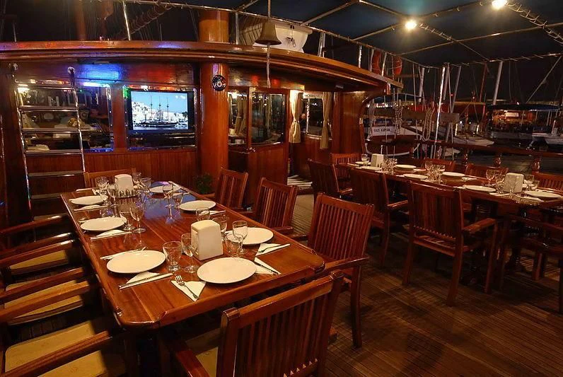 a restaurant with tables and chairs aboard BAHRIYELI C Yacht for Sale