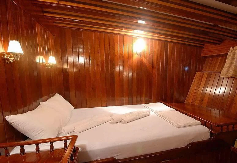 a room with a bed and a wood wall aboard BAHRIYELI C Yacht for Sale